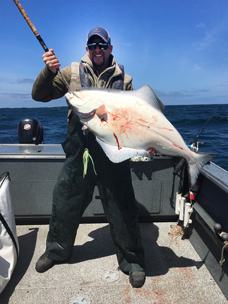 a man holding Oregon's Halibut fish
