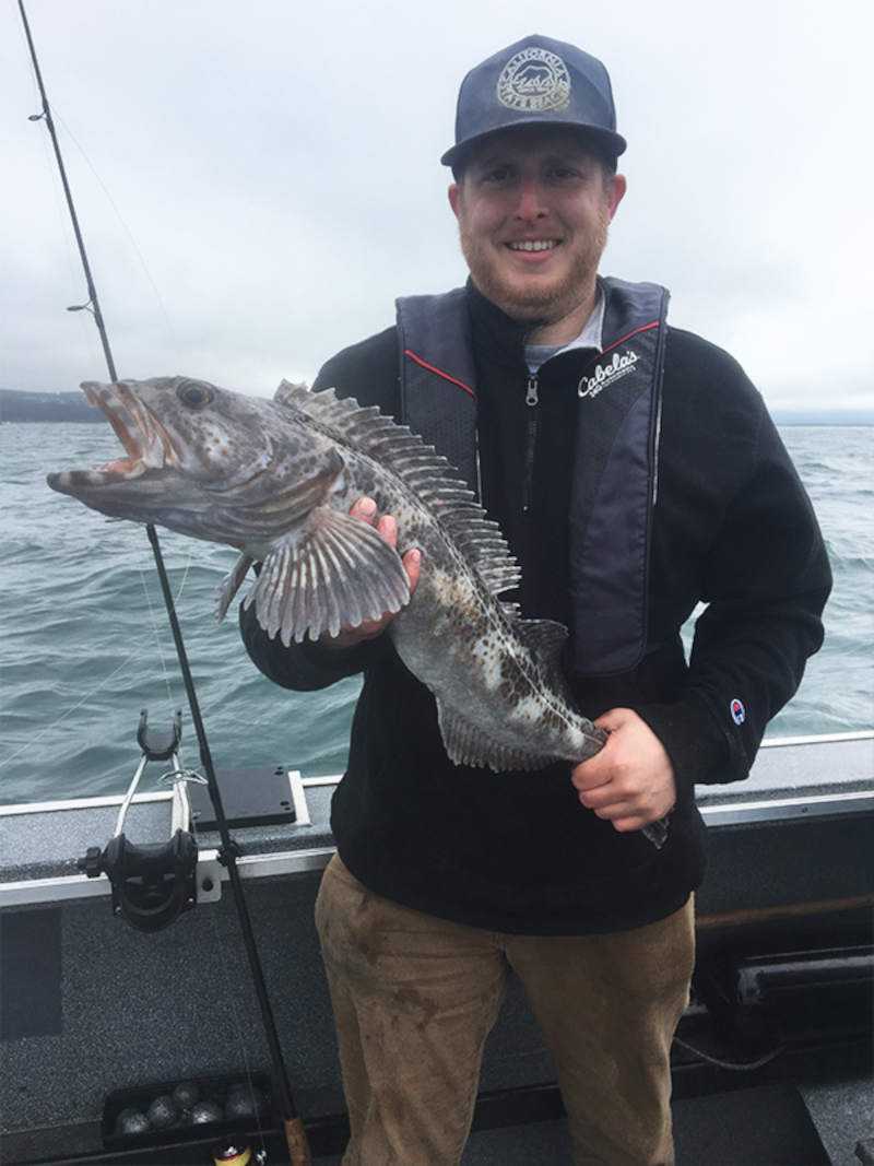 a man holding Oregon's Lingcod fish